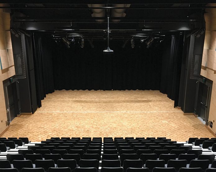 Compressed straw ceiling panel used in a school performing arts centre