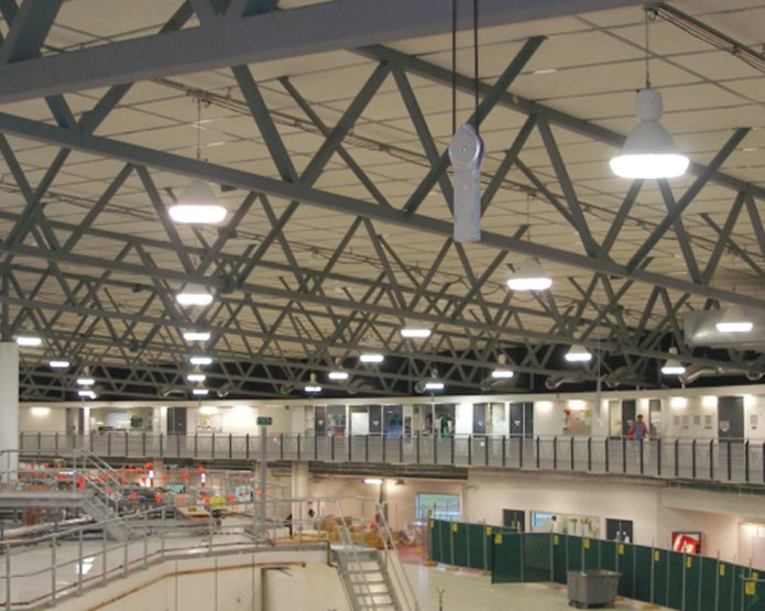 Compressed straw ceiling panel used in an industrial facility